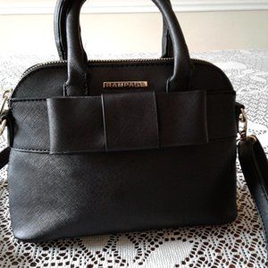 Mini Handbag with a bow in the front by Rampage. Comes with Cross Body Strap.